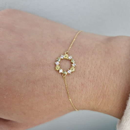 Armband i 18k guld med krans och stenar